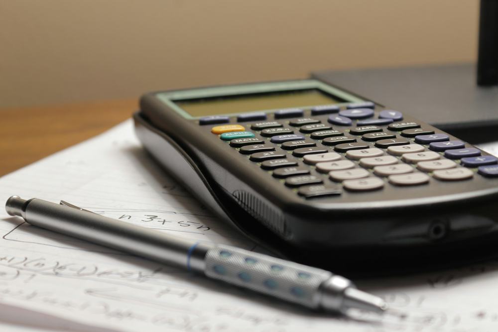 A calculator and a pen on financial documents