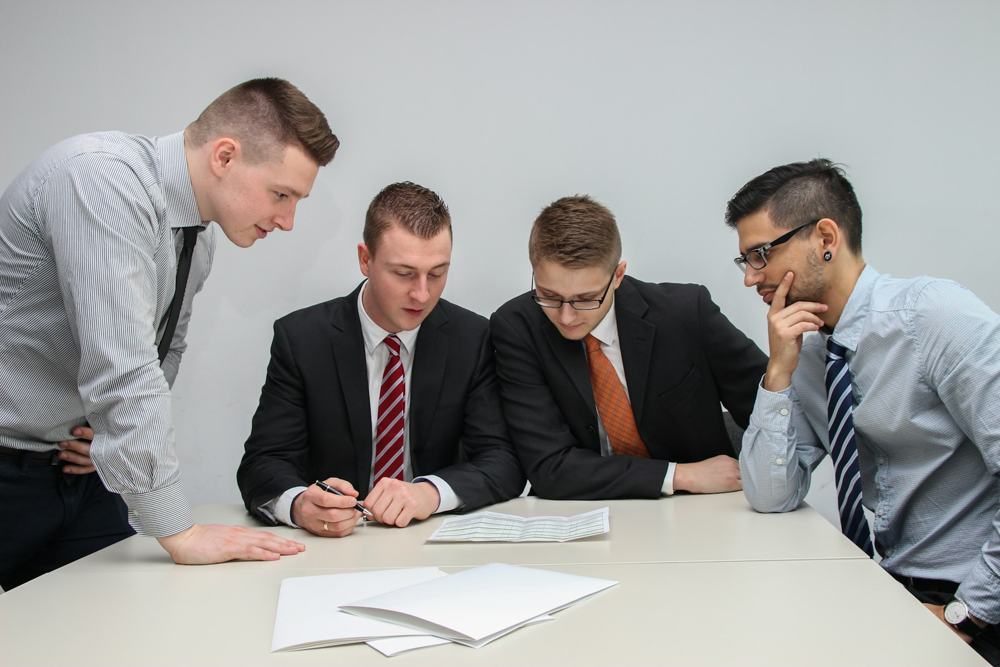 Founders discussing documents around a table
