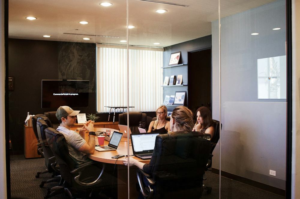 A team meeting in a glass-walled conference room