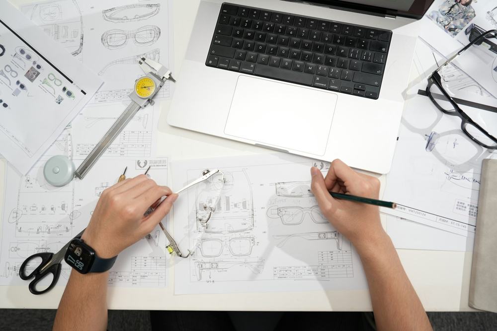Design drawings being drafted on a desk