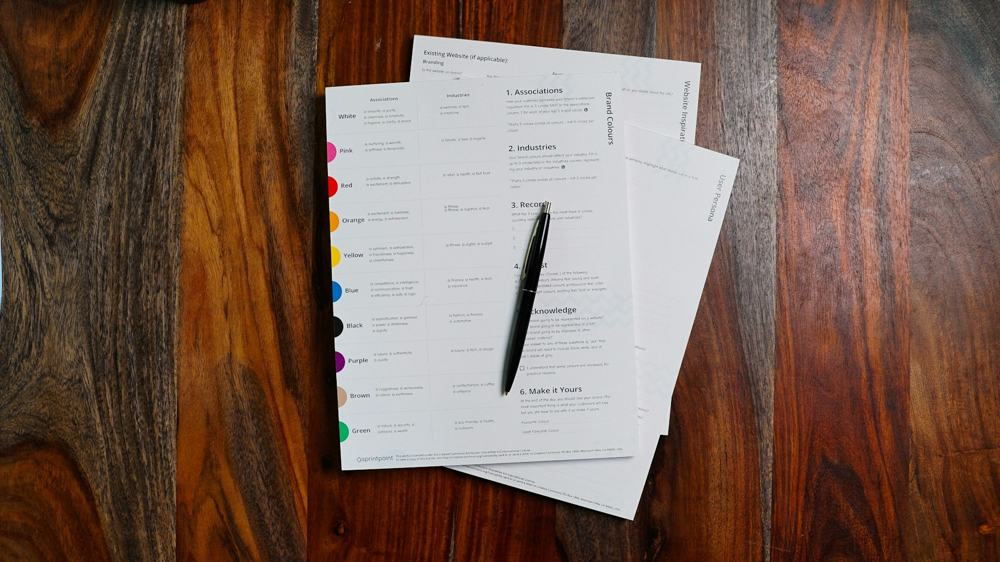 Contract pages and a pen on a wooden desk
