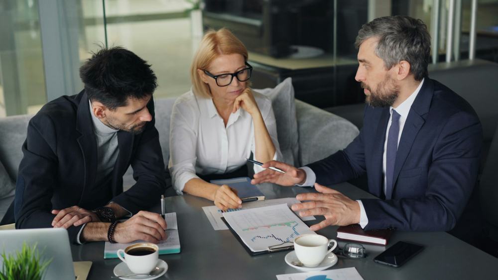 Professionals reviewing documents at a meeting table