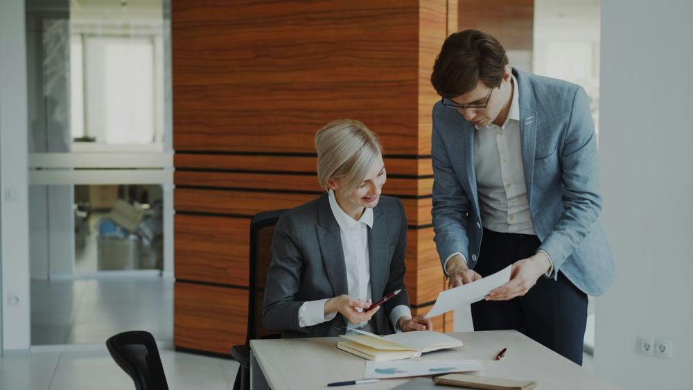 Two colleagues reviewing a document together
